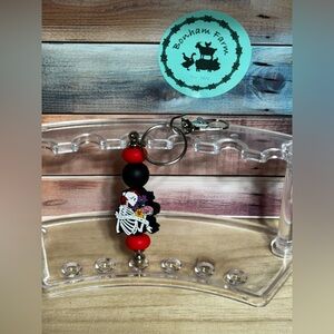 Red and Black Keychain with Skeleton Design